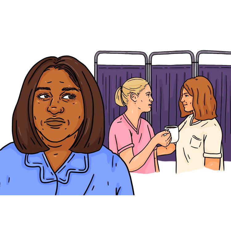 Anusha looks behind her at two white colleagues who are having a conversation. One of the women is holding a coffee cup, the other is reaching out her arms towards her white colleague and listening intently to what she is saying.