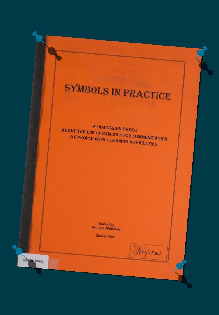 A photograph of the cover of the King’s Fund’s report, Symbols in Practice, on a dark blue background. Each of the four corners of the report cover have the graphic of a light-blue pin, as though the cover of the report is pinned to the background of the image. The cover is bright orange and on it is the title, as well as a subtitle that reads ‘A discussion paper about the use of symbols for communication by people with learning difficulties’. 